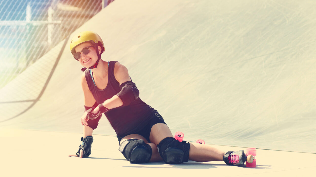 Happy woman falling roller skates.