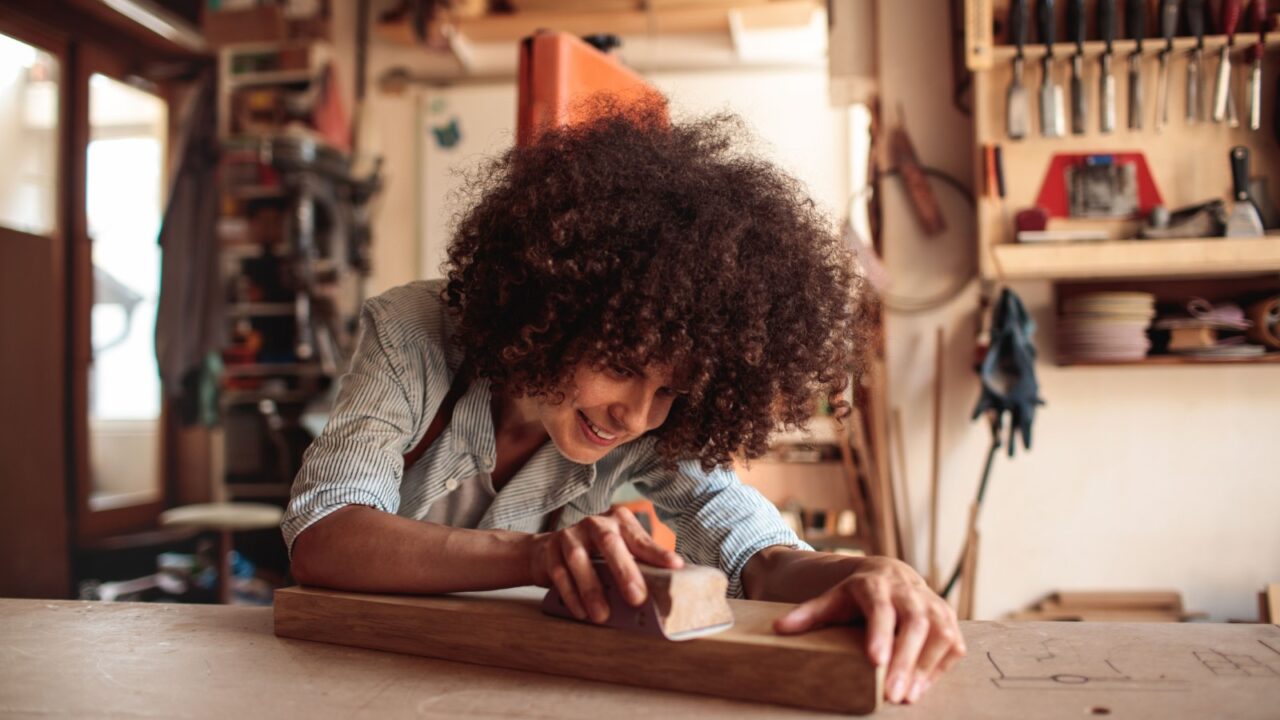 Happy woman working in workshop.